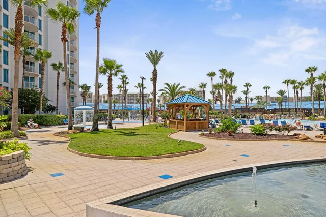 front view of a house with a yard and potted plants