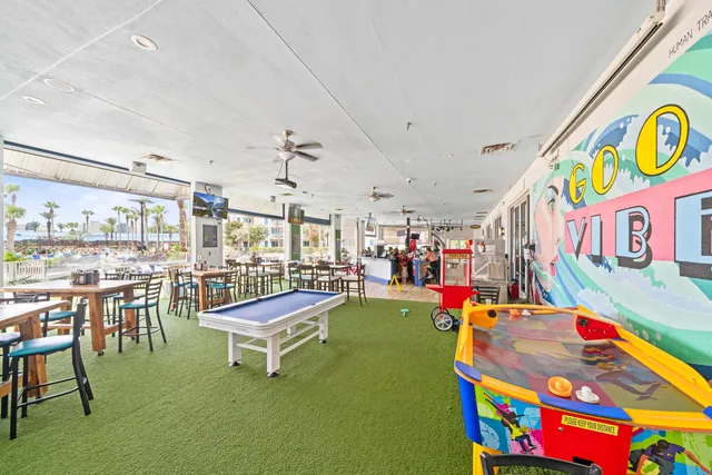 a living room with table chair and a potted plant