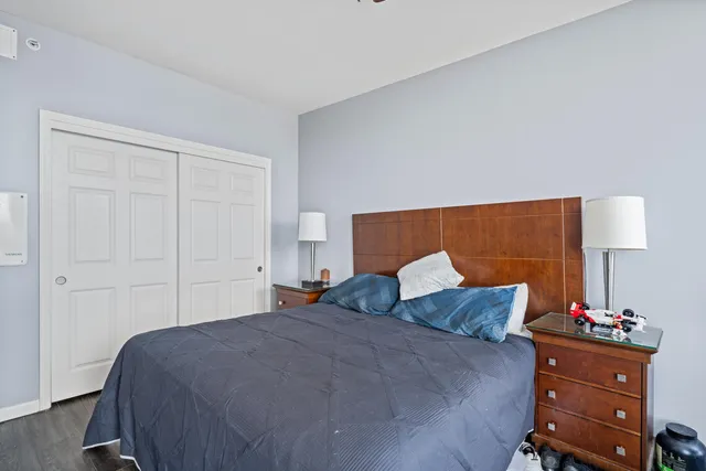 a bedroom with a bed and a night stand