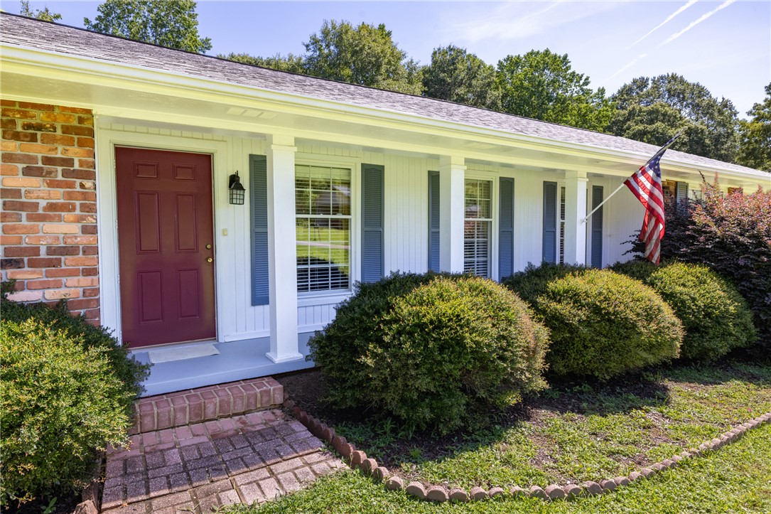 706 Pinewood Drive Pendleton, SC 29670 - Photo 2 of 35 A classic brick and siding residence features a welcoming front porch with mature landscaping.