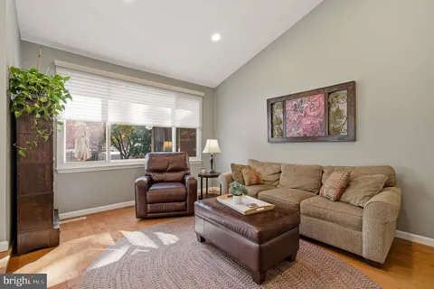 a dining room with furniture a chandelier and window