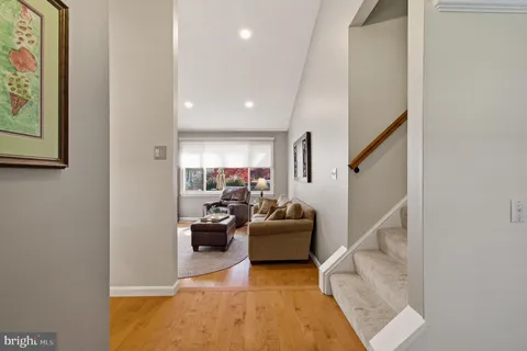 a living room with furniture a fireplace and a large window
