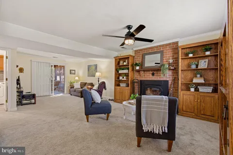 a living room with furniture a fireplace and a window
