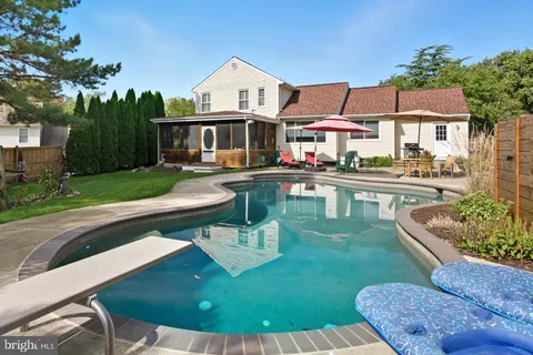 a view of a house with pool porch and sitting area