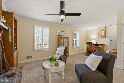 a living room with furniture a couch and a flat screen tv