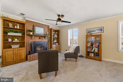 a living room with furniture a flat screen tv and large window