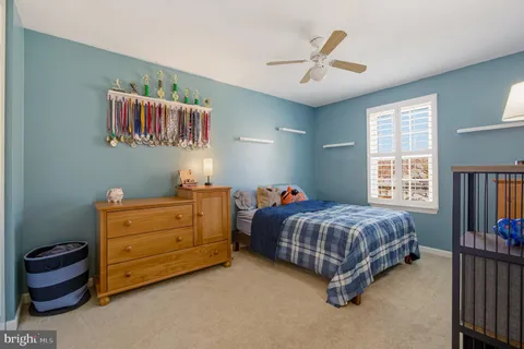 a bedroom with a bed lamp and a window