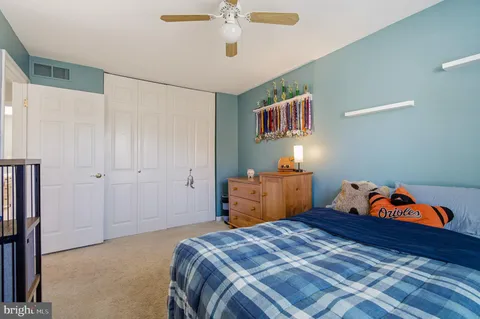 a view of a room that has a bed and a walk in closet