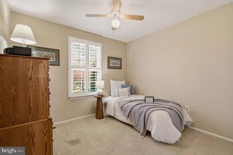 a spacious bedroom with a bed and a flat screen tv