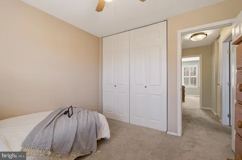 a spacious bedroom with a bed and a walk in closet