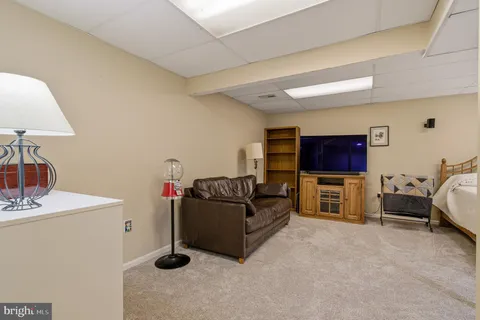 a living room with furniture a table and chairs