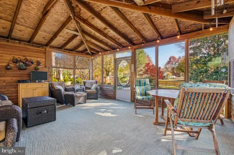 a backyard of a house with yard and outdoor seating