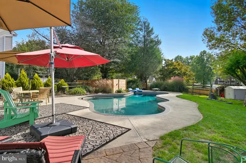 a aerial view of a house next to a yard