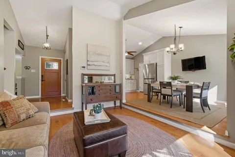a living room with furniture chess board and a window