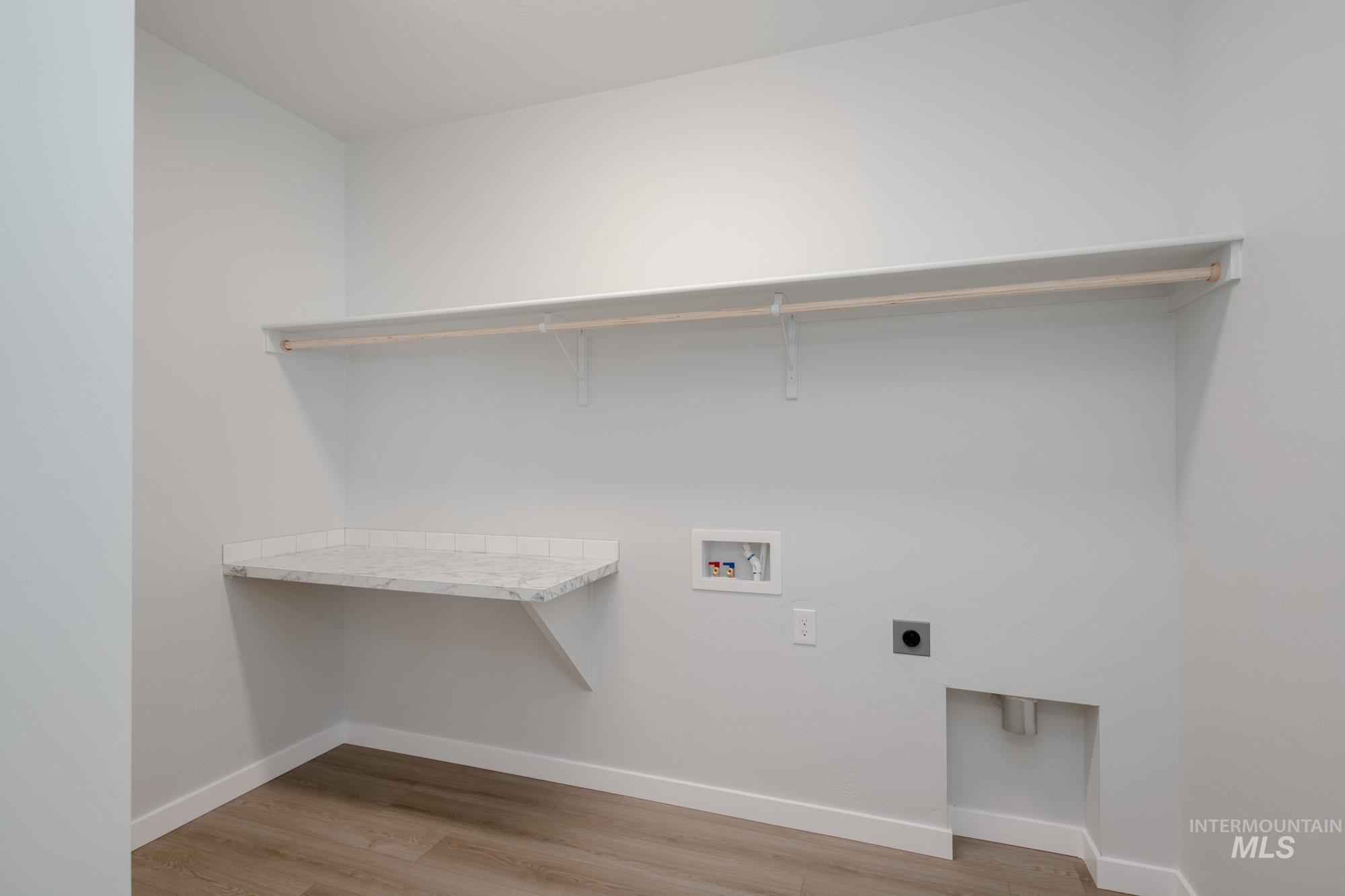 5131 Castleton Avenue Nampa, ID 83686 - Photo 20 of 25 Washroom with electric dryer hookup, hookup for a washing machine, and light wood-style flooring