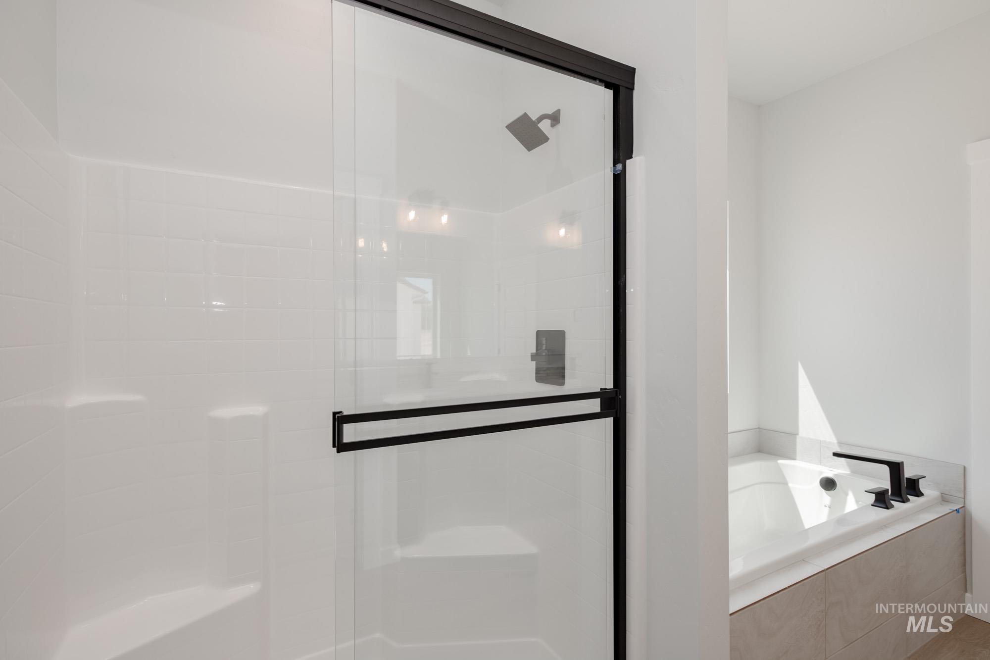 5131 Castleton Avenue Nampa, ID 83686 - Photo 25 of 25 Bathroom with a stall shower and a bath