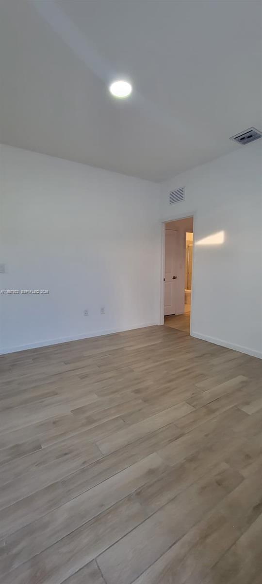 27118 Southwest 132 Ct Road Homestead, FL 33032 - Photo 8 of 9 a view of an empty room and wooden floor