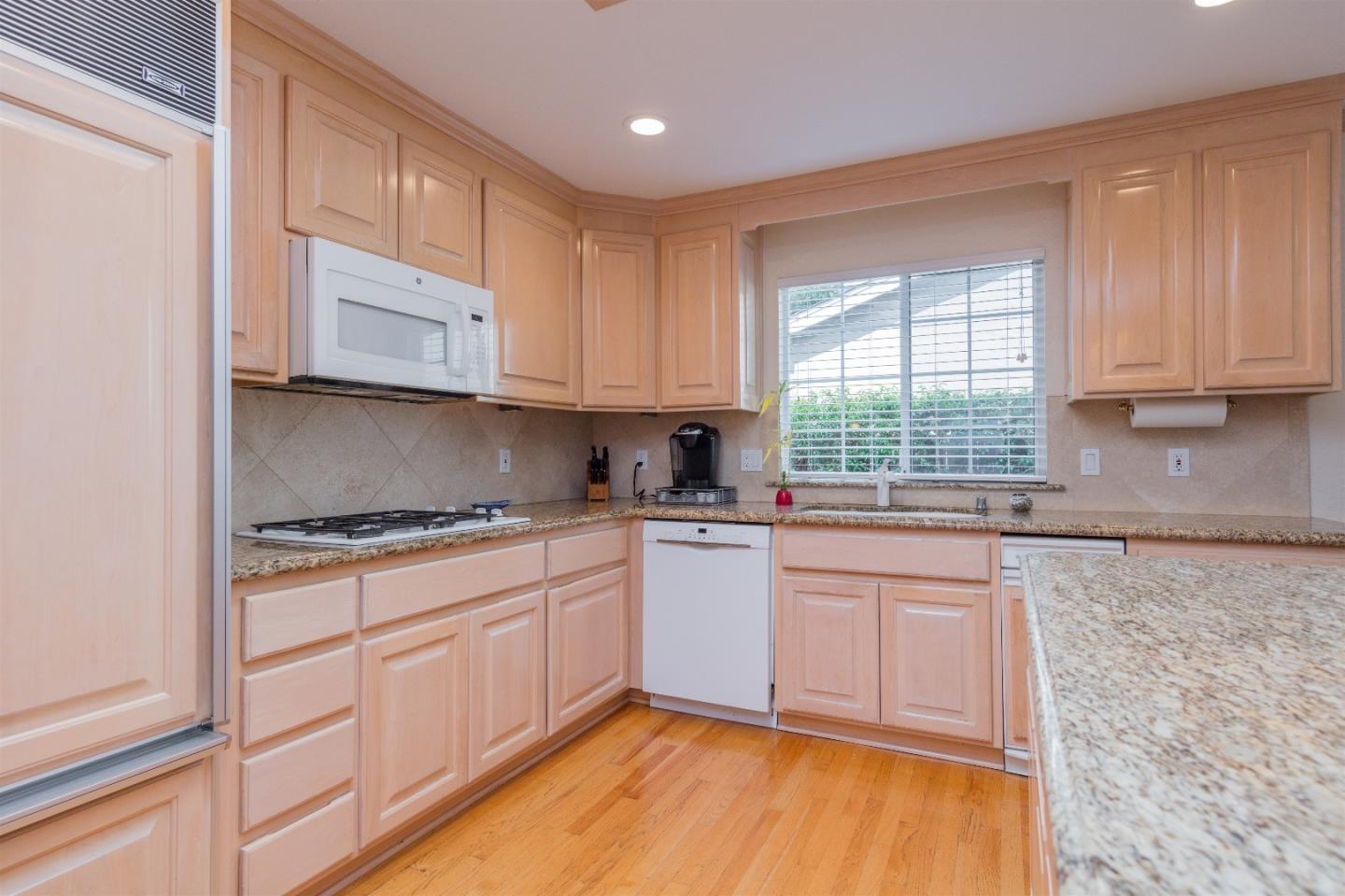 1686 Ebbetts Drive Campbell, CA 95008 - Photo 11 of 31 a kitchen with granite countertop cabinets stainless steel appliances a sink and a window