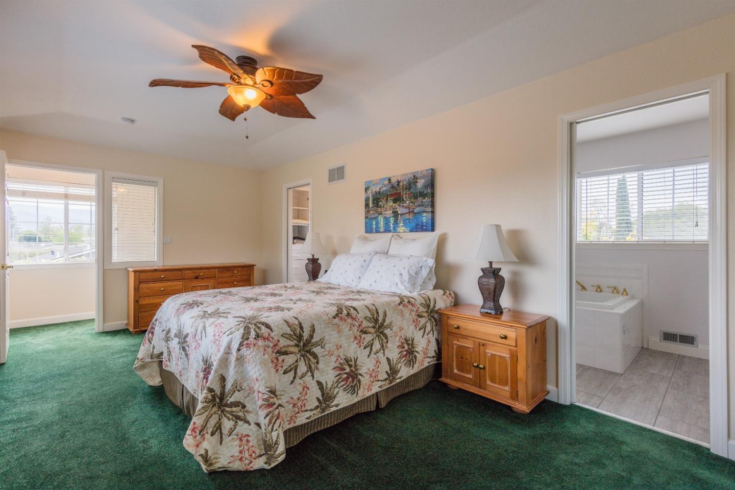 1686 Ebbetts Drive Campbell, CA 95008 - Photo 22 of 31 a bedroom with a bed and a chandelier