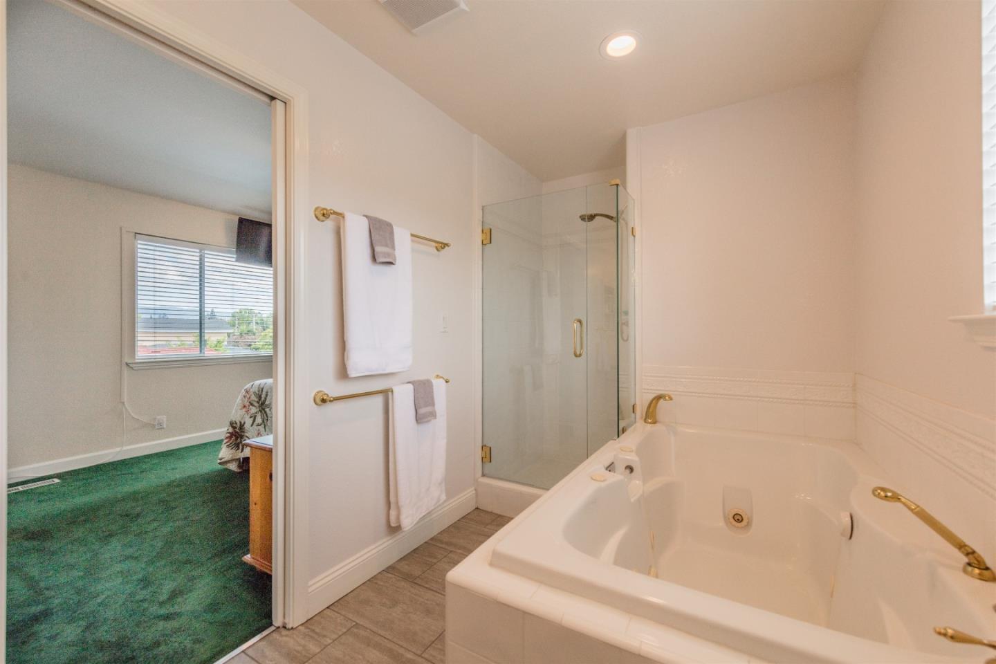 1686 Ebbetts Drive Campbell, CA 95008 - Photo 25 of 31 a bathroom with a bathtub and a shower