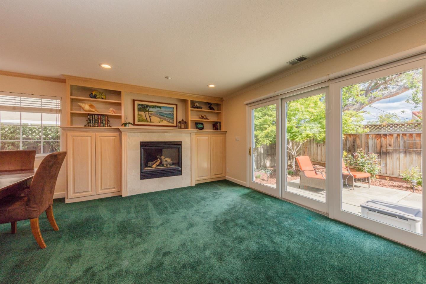1686 Ebbetts Drive Campbell, CA 95008 - Photo 6 of 31 a view of an empty room with a fireplace and a floor to ceiling window