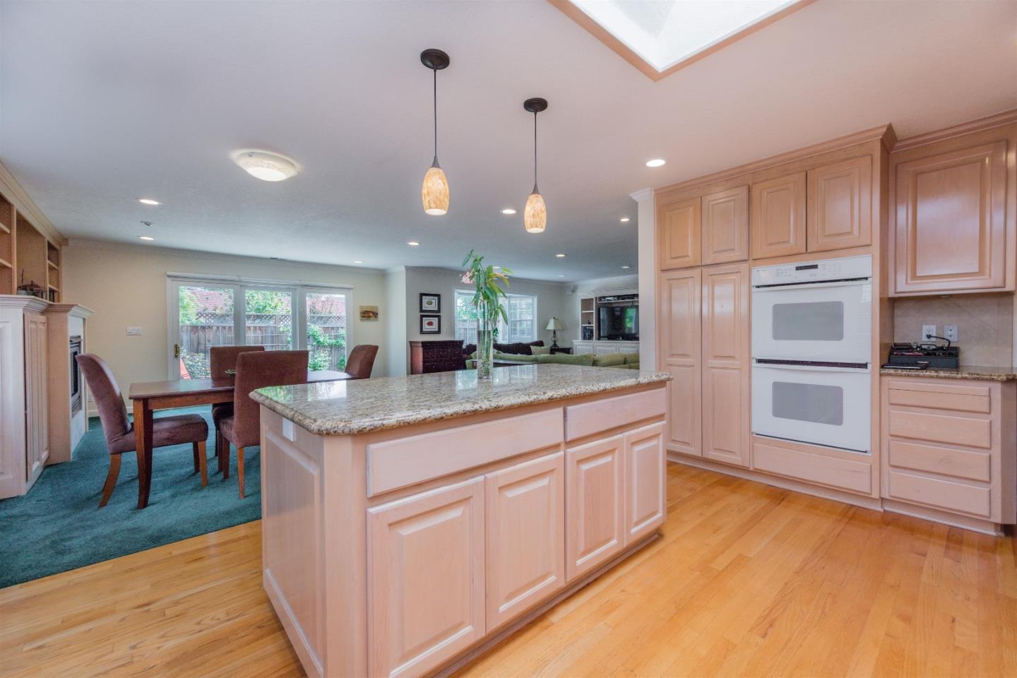 1686 Ebbetts Drive Campbell, CA 95008 - Photo 8 of 31 a kitchen with stainless steel appliances granite countertop kitchen island wooden cabinets and granite counter tops