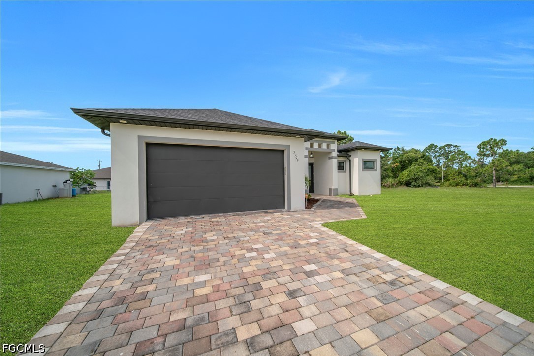 3509 38th Street Southwest Lehigh Acres, FL 33976 - Photo 8 of 47 a front view of a house with a yard