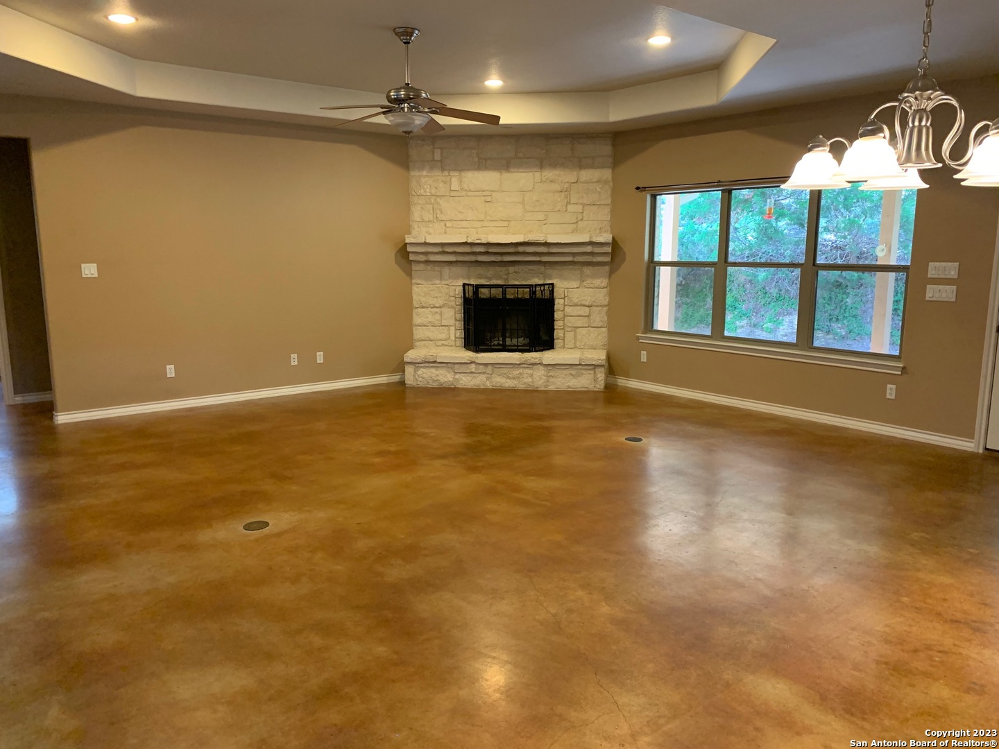 8729 Fair Oaks Parkway Fair Oaks Ranch, TX 78015 - Photo 4 of 11 an empty room with windows and fireplace