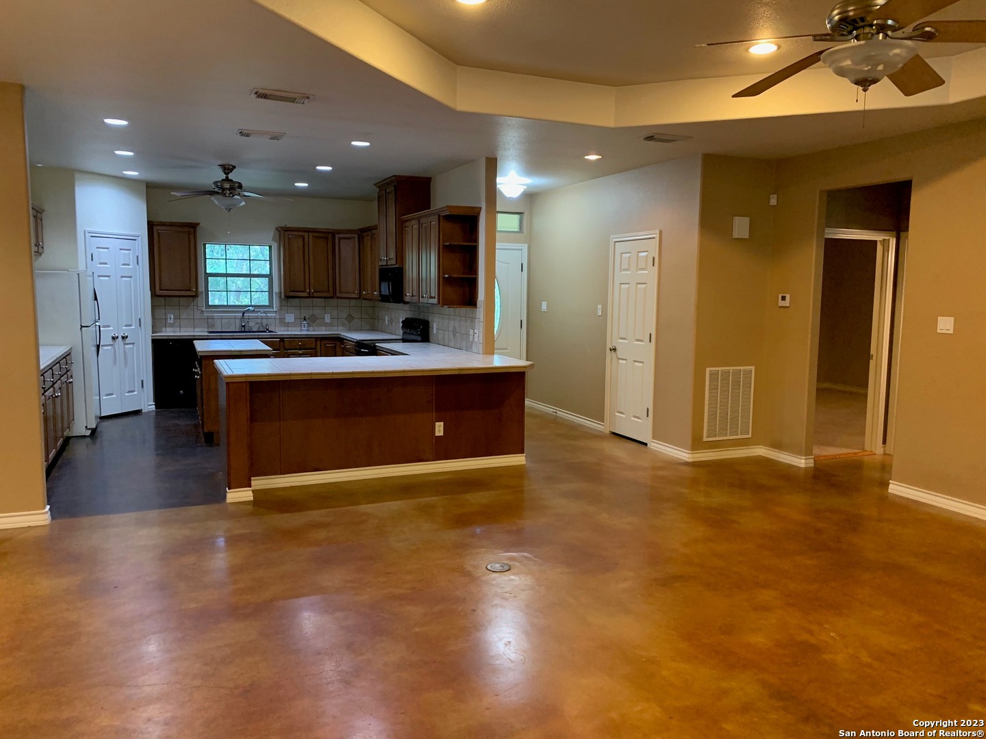 8729 Fair Oaks Parkway Fair Oaks Ranch, TX 78015 - Photo 6 of 11 a view of kitchen with kitchen island a sink appliances and a living room