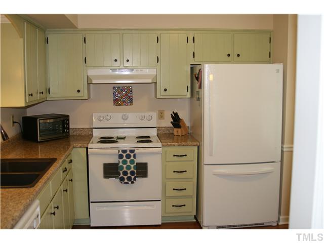 1524 Woodcroft Drive Raleigh, NC 27609 - Photo 11 of 25 a kitchen with a stove and a refrigerator