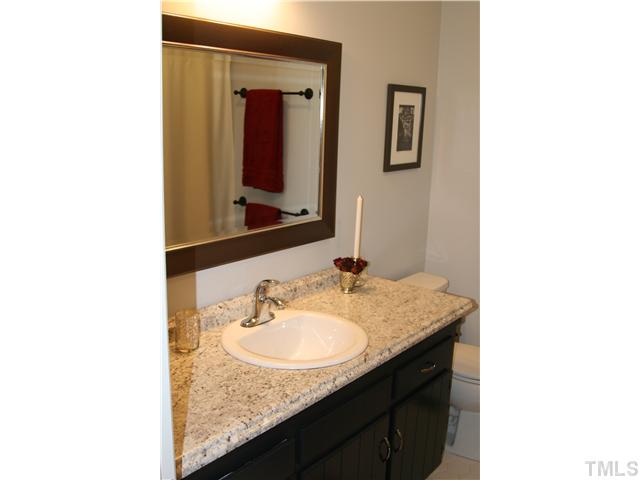 1524 Woodcroft Drive Raleigh, NC 27609 - Photo 14 of 25 a bathroom with a sink and a mirror