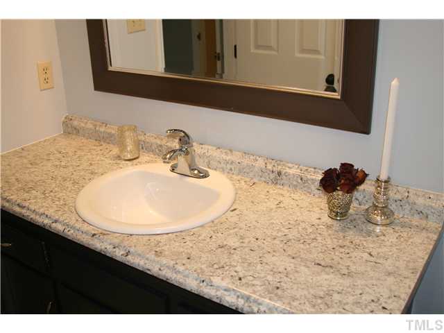 1524 Woodcroft Drive Raleigh, NC 27609 - Photo 15 of 25 a bathroom with a sink and a mirror