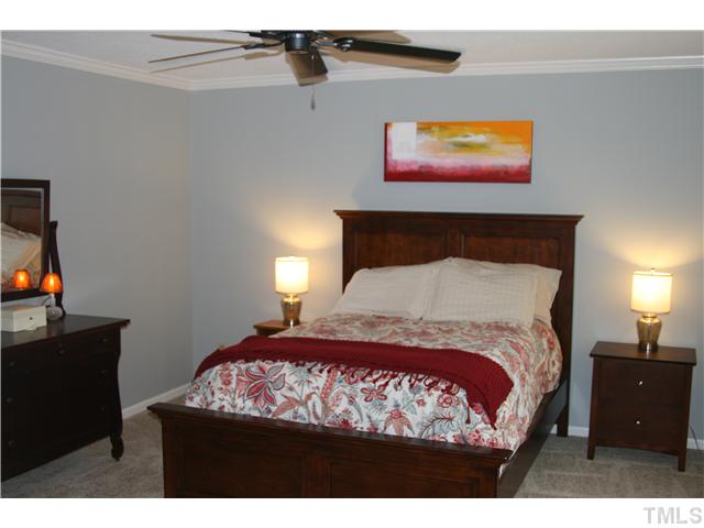 1524 Woodcroft Drive Raleigh, NC 27609 - Photo 16 of 25 a bedroom with a bed and painting on the wall