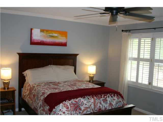 1524 Woodcroft Drive Raleigh, NC 27609 - Photo 17 of 25 a bedroom with a bed and a painting on the wall