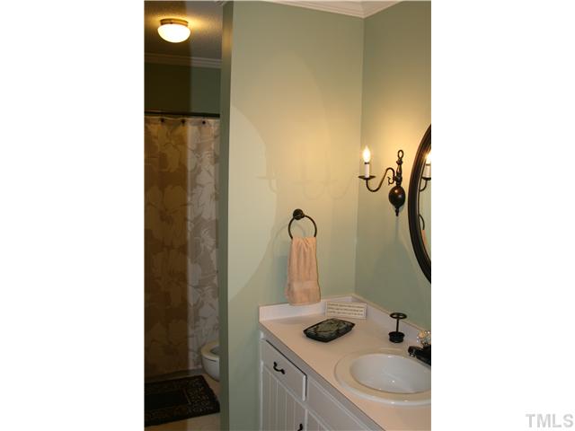 1524 Woodcroft Drive Raleigh, NC 27609 - Photo 18 of 25 a bathroom with a sink and mirror