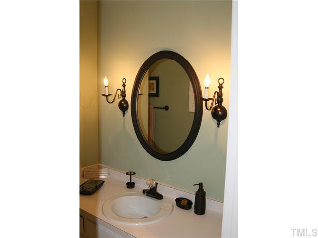 1524 Woodcroft Drive Raleigh, NC 27609 - Photo 19 of 25 a bathroom with a sink and a mirror