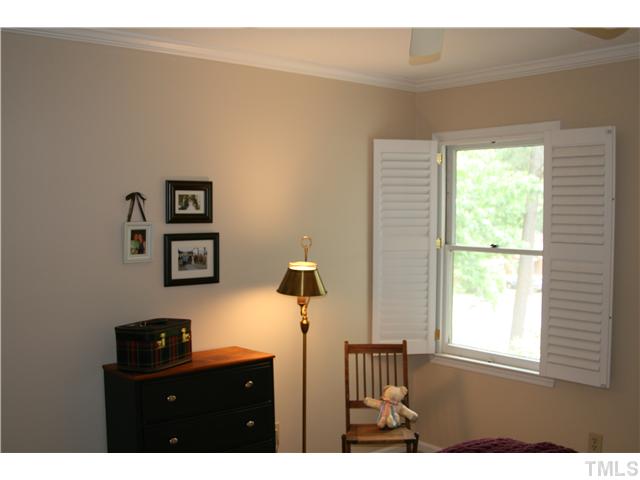 1524 Woodcroft Drive Raleigh, NC 27609 - Photo 21 of 25 a bathroom with a sink a mirror and a window