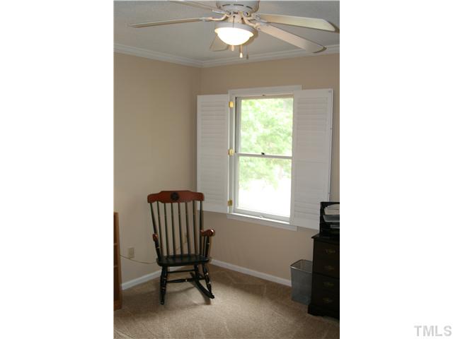1524 Woodcroft Drive Raleigh, NC 27609 - Photo 22 of 25 a view of a room with a window and chair
