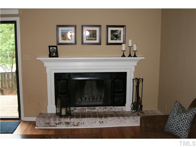 1524 Woodcroft Drive Raleigh, NC 27609 - Photo 5 of 25 a living room with a fireplace and a window