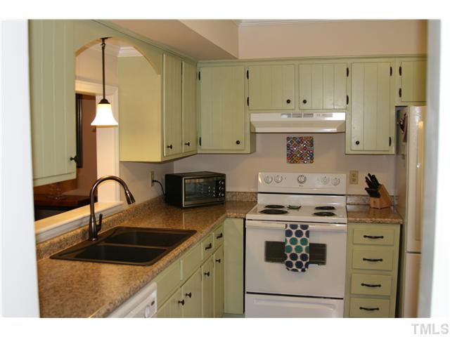 1524 Woodcroft Drive Raleigh, NC 27609 - Photo 10 of 25 a kitchen with a sink a stove and cabinets