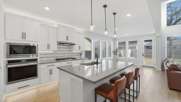 a kitchen with a stove a sink and a refrigerator