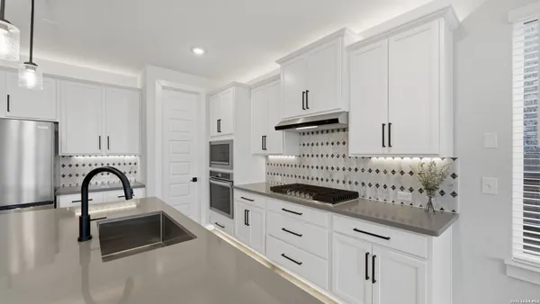 a kitchen with granite countertop a stove and a sink