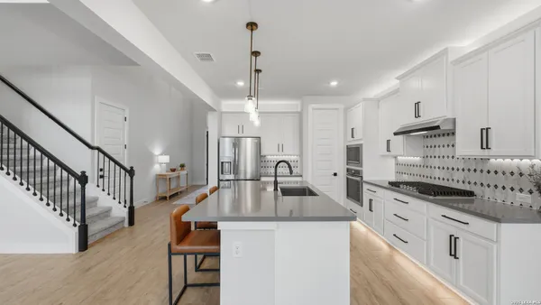 a kitchen with counter top space a sink stainless steel appliances and cabinets