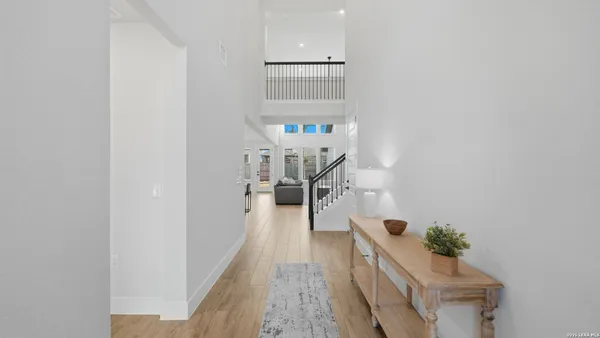 a hallway with a white house next to a window