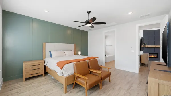 a bedroom with a bed and a chandelier