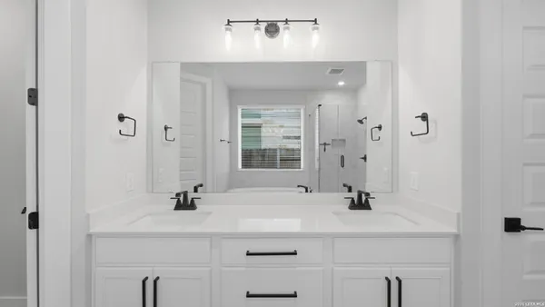 a bathroom with a sink vanity and a mirror