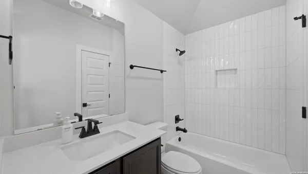 a bathroom with a sink toilet tub and shower