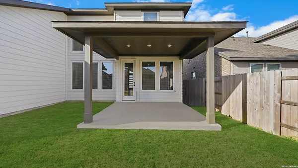a view of a house with a backyard