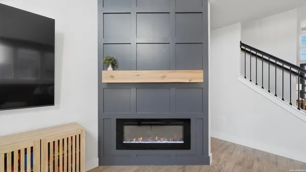 a bathroom with a fireplace and a flat screen tv