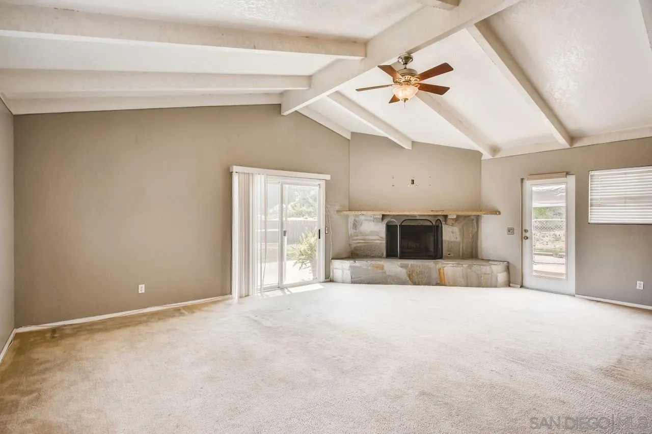 139 Landale Lane El Cajon, CA 92019 - Photo 4 of 11 a view of a livingroom with a ceiling fan and wooden floor